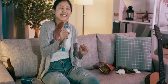 Garota feliz cantando sozinha em casa