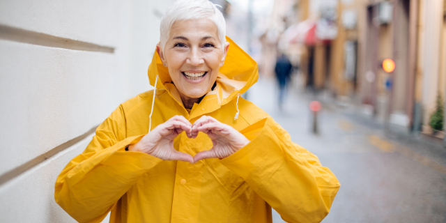 Mulher fazendo o formato de coração com as mãos