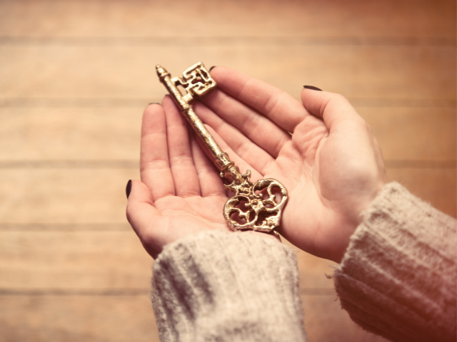 Pessoa segurando chave de ouro