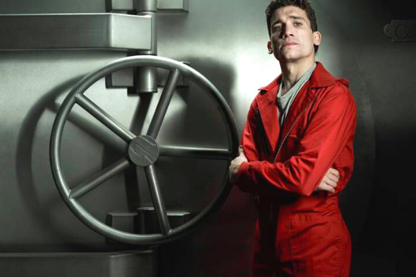 Denver ao lado do cofre do banco da Espanha de braços cruzados