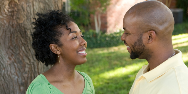 Homem e mulher se olhando e sorrindo um para o outro