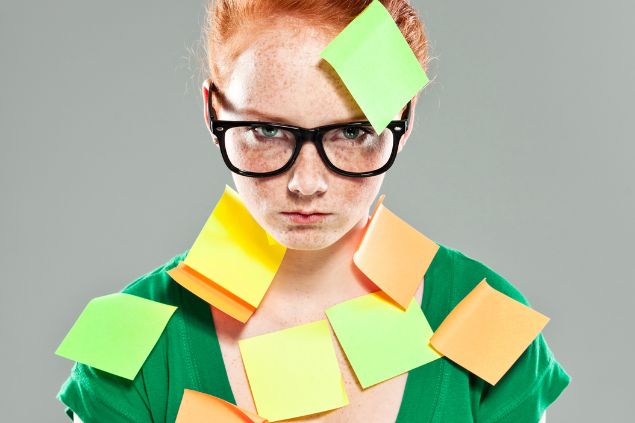 Menina ruiva com diversos post its colados em seu corpo