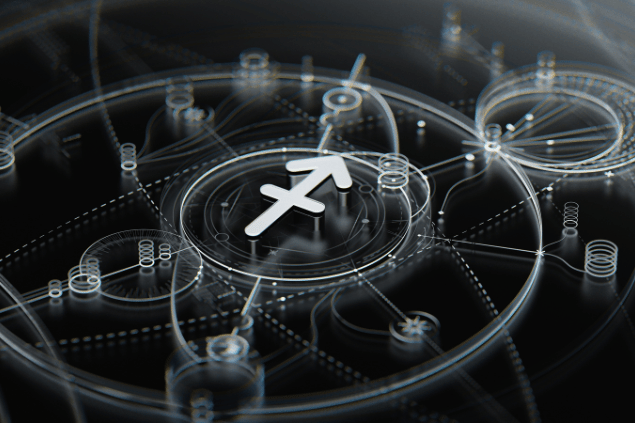 No foco da imagem, há o símbolo do signo de Sagitário e, ao fundo, há um mapa astrológico.