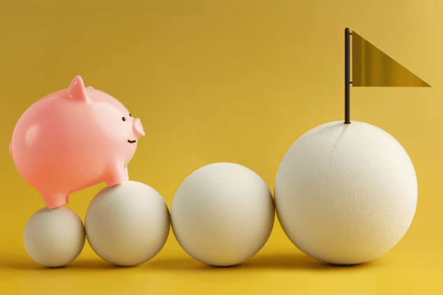 siriwannapatphotos / Canva Pro Representação de objetivos financeiros. Porquinho tentando alcançar uma bandeira.
