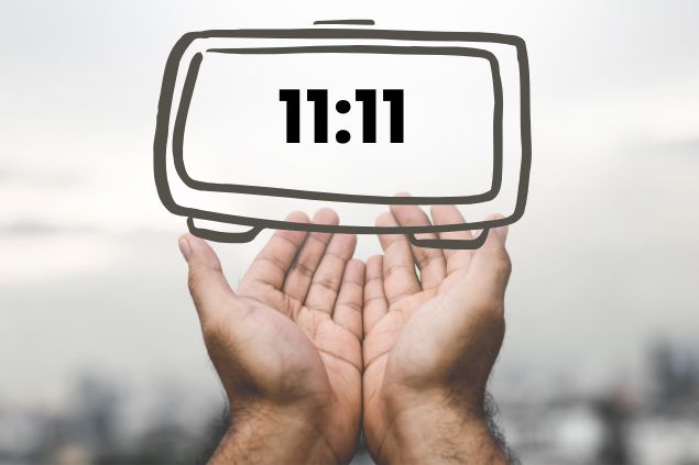 Imagem de um relógio marcando 11:11 sendo segurando pelas mãos de um homem.