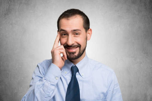 Homem com os dedos na cabeça, indicando inteligência