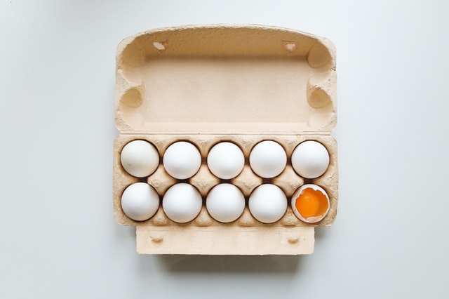 Ovo quebrado dentro de caixa de ovos.